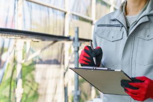 バインダーとペンを持ち、最終確認をしている作業員の様子